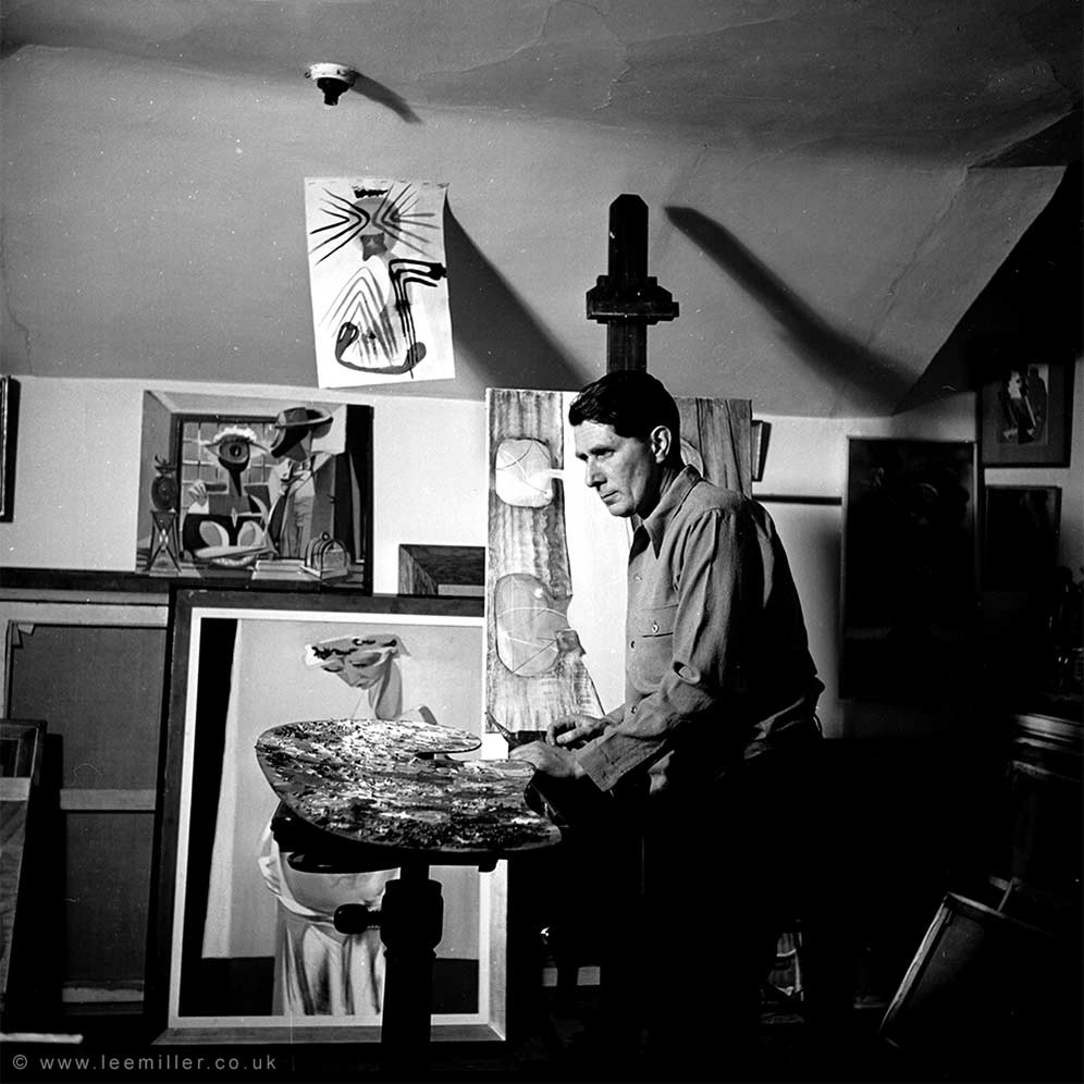 Roland Penrose in his studio surrounded by his paintings