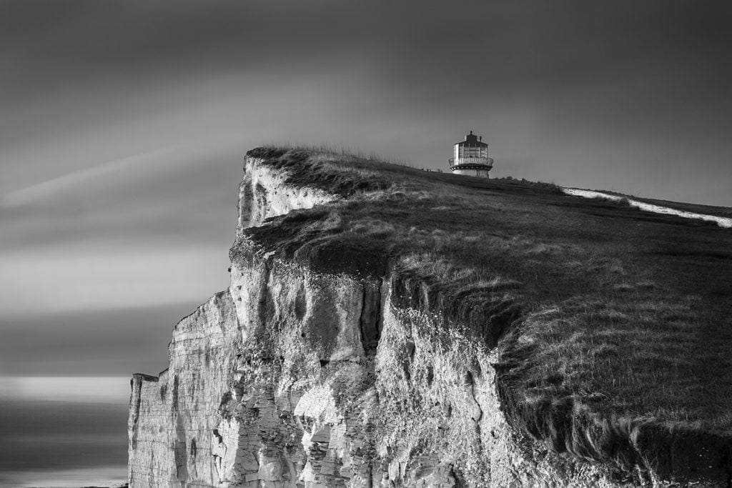 Photograph of cliff edge and lighthouse by Lin Gregory